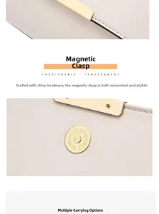 Detail of the golden magnetic closure and textured leather on a minimalist cream handbag