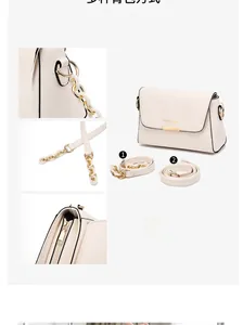 Detail of cream shoulder bag with dual straps, chain decor and gold fashion logo
