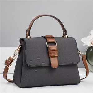 Contrast grey fabric tote bag with brown leather handles and adjustable shoulder strap