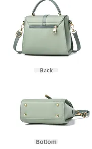 Détails du sac bandoulière vert montrant la fermeture éclair arrière et pieds en métal