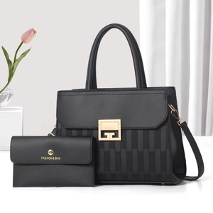 Elegant black leather tote bag and envelope wallet set with gold hardware and snake pattern