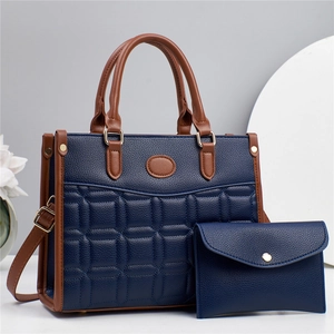 Navy blue square stitched tote bag with brown handles and matching envelope pouch set