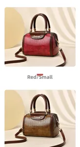 Detail of red and brown crocodile pattern PU leather Boston bags with gold hardware