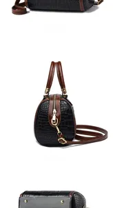 Detail of contrast color crocodile pattern PU leather handbag with gold metal hardware
