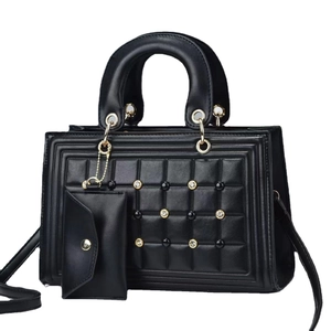 Quilted black leather tote bag with elegant beaded detailing and gold hardware accents