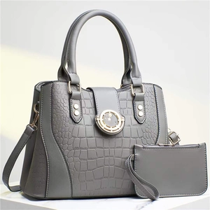 Grey crocodile embossed two-piece tote bag set with gold hardware on white marble