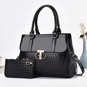 Lizard pattern black tote bag set with golden T-lock and matching clutch purse