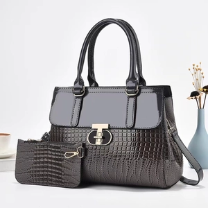 Chic dark grey 2pcs set tote bag with lizard texture and gold T-shaped clasp on white desk