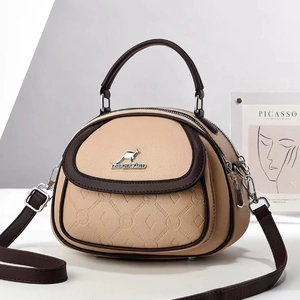 Contrast color beige and brown crossbody shell bag with grainy faux leather texture
