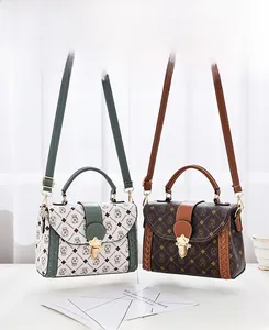 Detailed view of woven contrast color flap bags with bear badges and metal locks