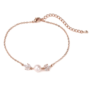 Detailed view of rose gold bracelet with leaf-shaped crystals and a central pearl