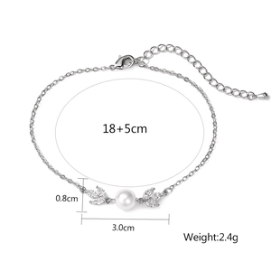 Elegant silver bracelet featuring white pearl and leaf-shaped cubic zirconia elements