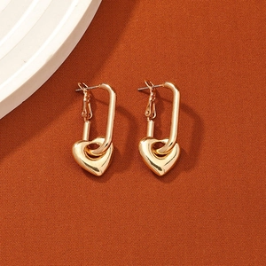 Elegant gold-plated geometric hoop earrings with polished heart pendants on brown background