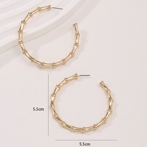 Chic 5.5cm golden C-shaped bamboo texture hoop earrings with elegant polished finish