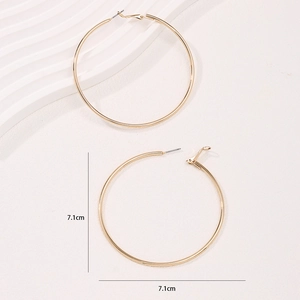 Polished golden 7.1cm oversized hoop earrings with a minimalist metallic mirror finish