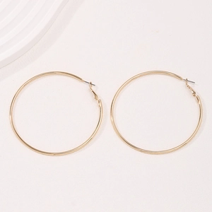 Minimalist large gold hoop earrings for women with polished metallic finish and clasp closure