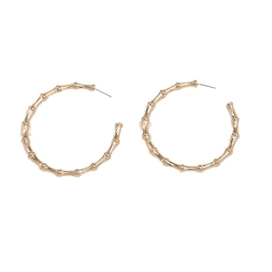 Classic golden bamboo style hoop earrings with a textured metal finish on white background