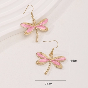Pink enamel dragonfly hook earrings in gold finish measuring 4.6cm by 3.5cm