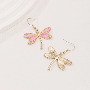 Pink enamel dragonfly drop earrings with golden textured metal wings on white background