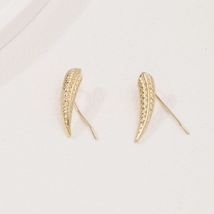 Minimalist golden leaf wheat ear earrings with detailed feather texture on white background