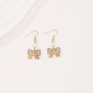 Elegant gold bow earrings with white pearl and sparkling crystals for women