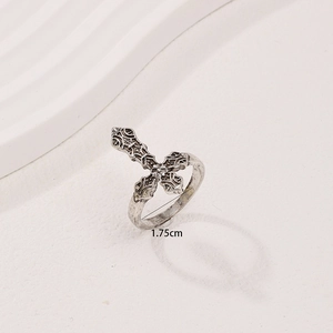Vintage silver cross ring with gothic embossed texture on a minimalist white background