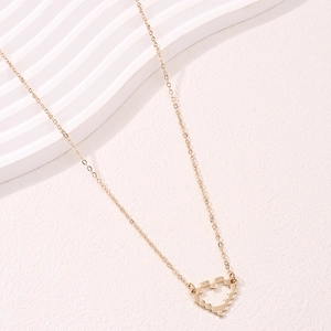 Golden necklace featuring a unique 8-bit pixelated hollow heart pendant on a thin link chain