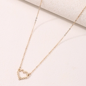 Golden necklace with pixel heart pendant on white stone, modern retro gaming style