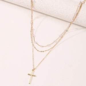 Elegant gold multi-layer necklace with white pearls and minimalist cross pendant