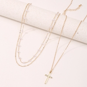 Gold layered necklace set featuring a cross pendant and white pearl beads for women