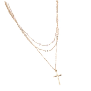 Three-layer gold necklace set featuring white pearls and a classic cross pendant