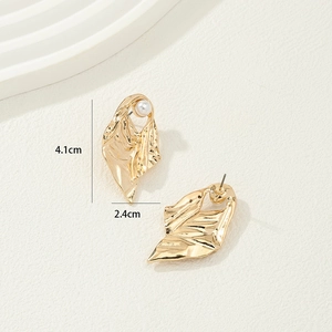 Golden irregular leaf earrings with white pearls and textured metal finish for women