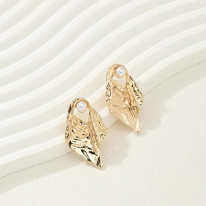 Irregular textured gold alloy earrings featuring round white pearls in a modern art style