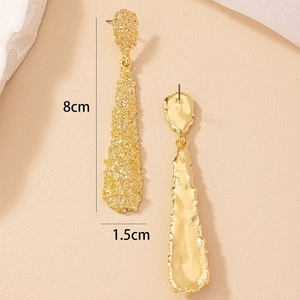 Textured gold drop earrings with irregular lava pattern measuring 8cm in length