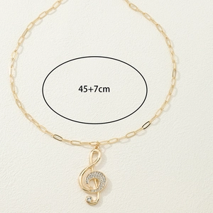 Elegant gold musical note pendant necklace with white crystals on a 45+7cm adjustable chain