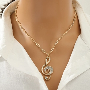 Sparkling gold musical note pendant necklace with clear crystals worn by model