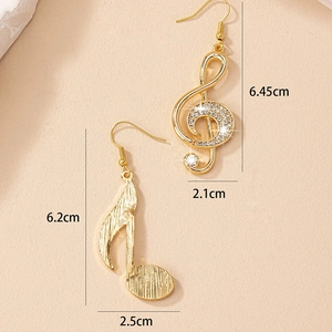 Gold asymmetrical music note earrings with rhinestone G-clef and brushed texture finish