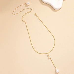 Detailed close-up of golden Y-shaped necklace with elegant baroque pearl drop pendants