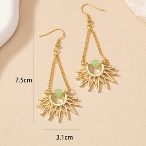 Close-up of bohemian gold sun earrings with green bead detailing, 7.5cm drop length