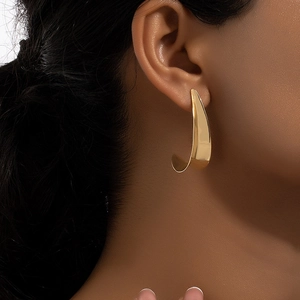 Polished gold geometric C-shaped hoop earrings featuring a minimalist streamlined design