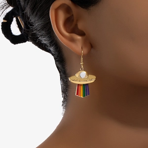 Gold UFO shaped drop earrings with colorful rainbow stripes shown on model