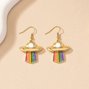 Chic gold UFO earrings with colorful rainbow drip oil design on a warm textured background