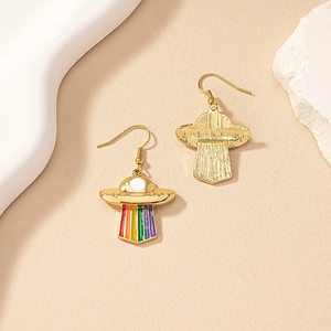 Detail of UFO earrings showing rainbow enamel front and brushed gold metal back textures
