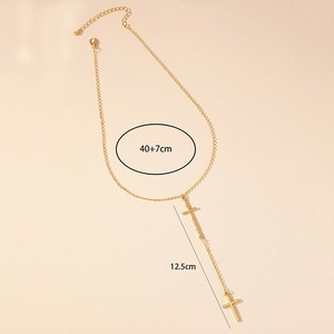 Detail of gold double cross pendant necklace with 12.5cm tassel and chain measurements