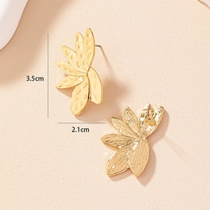 Detailed view of hammered gold leaf earrings with measurements 3.5cm by 2.1cm size