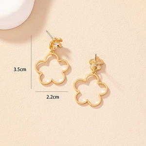 Macro view of gold hollow flower earrings with diamond accents, size 3.5cm by 2.2cm