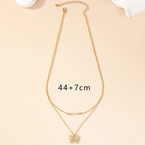Double-layered gold bow necklace with rhinestones and 44+7cm length adjustment