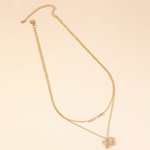 Elegant gold-tone double-layered necklace featuring sparkling bow and bar pendants