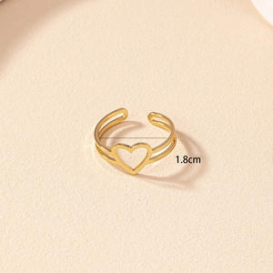 Detail shot of golden open ring with hollow heart pattern showing 1.8cm inner diameter