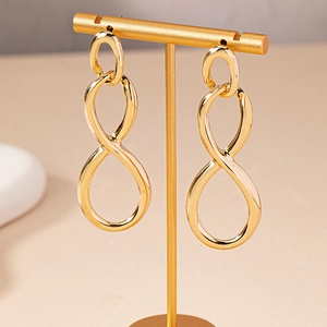 Minimalist gold infinity number 8 earrings on a premium T-stand jewelry display